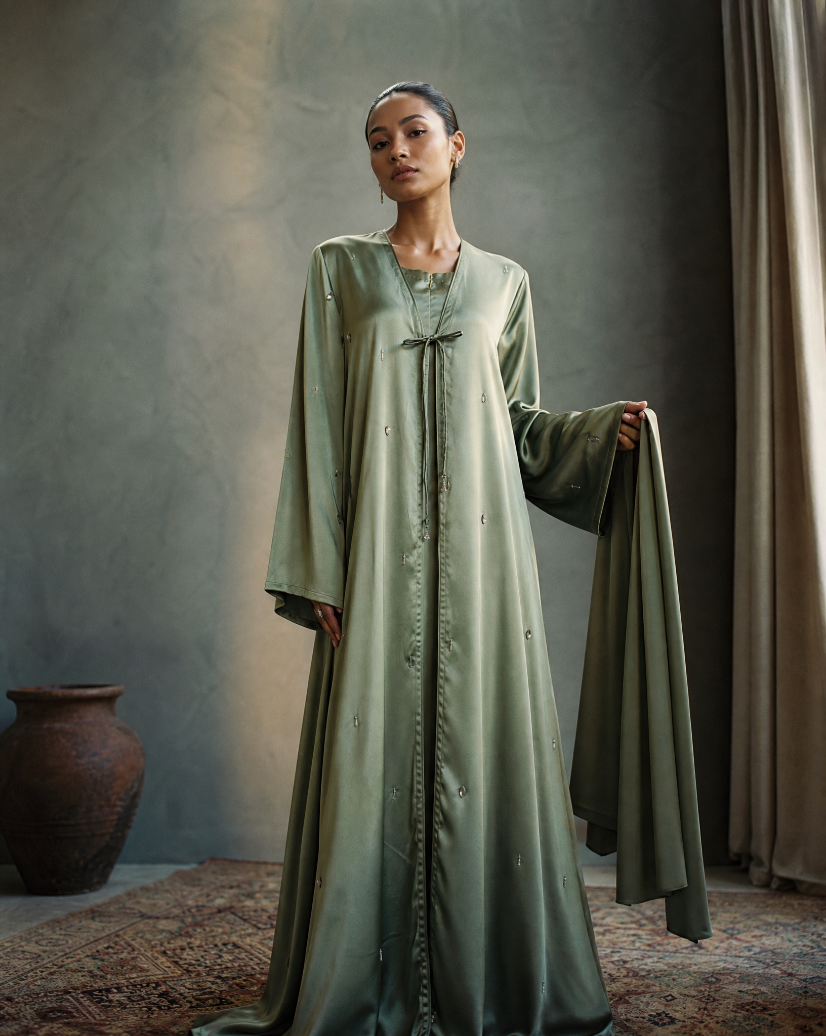 Woman wearing a long green Abaya